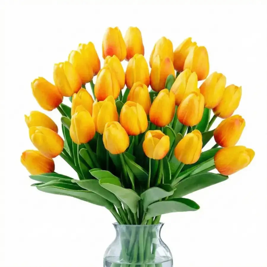Bouquet vibrant de tulipes artificielles jaunes en vase verre clair